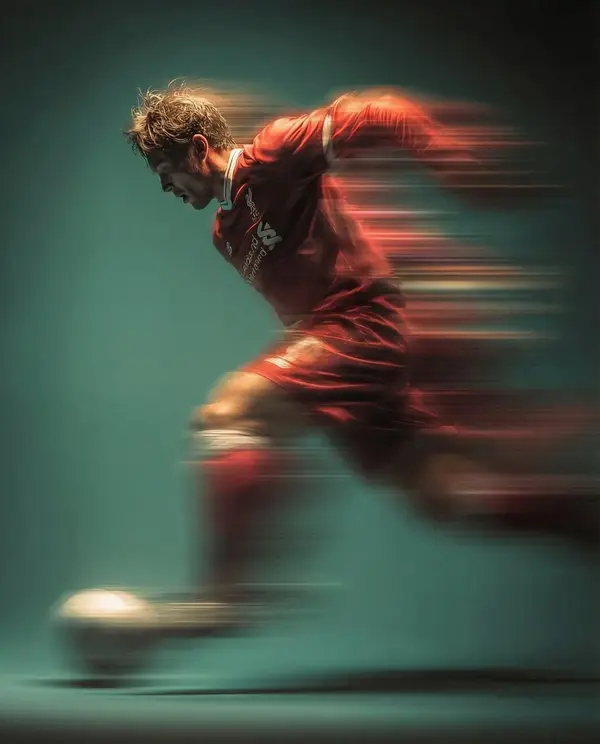 Panning shot of a mysterious soccer player in red proffesional soccer jearsy… — Nano Banana Pro prompt by @ChillaiKalan__