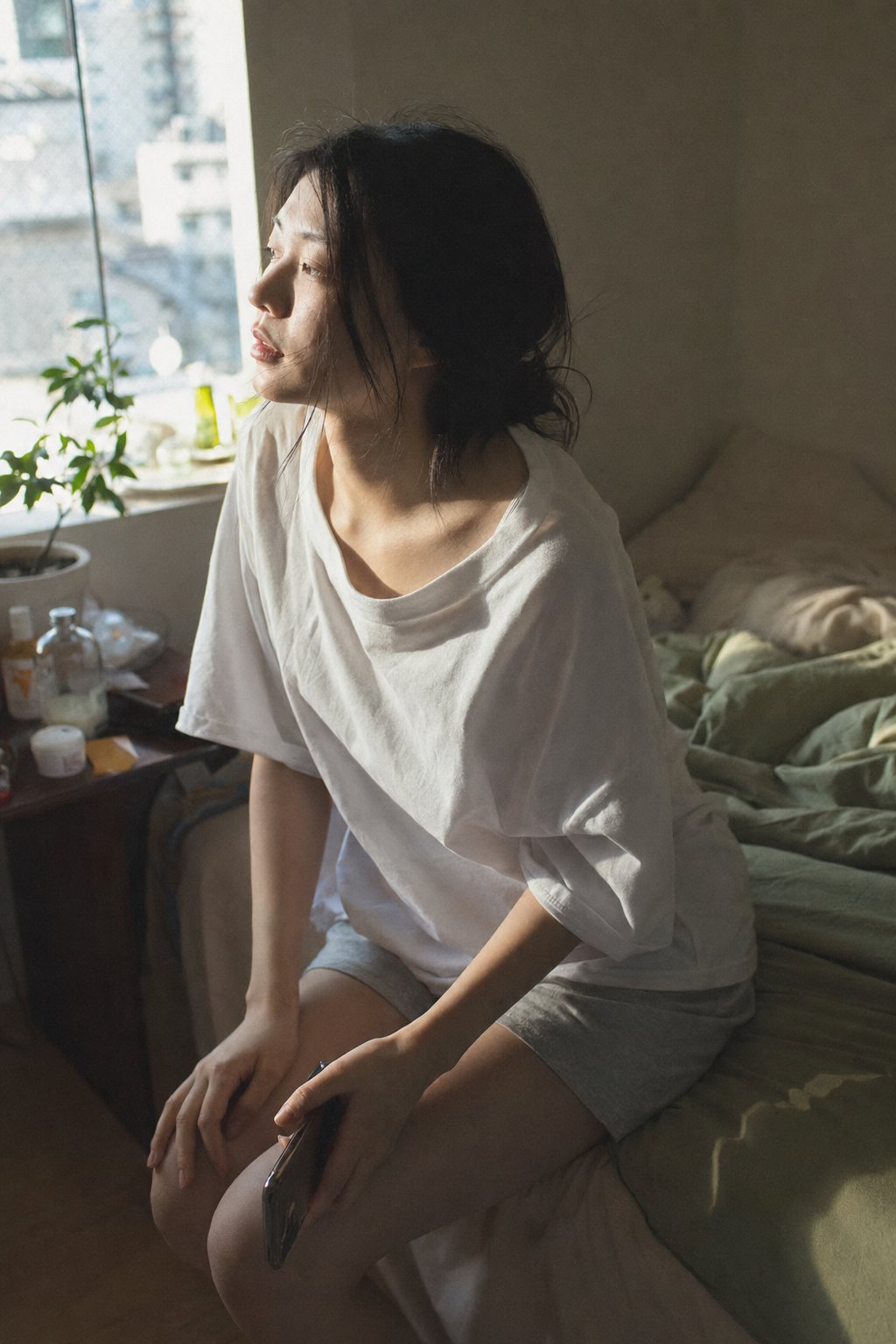 A close-medium shot of a young Japanese woman in her bedroom on an ordinary… — AI-generated image by @ToroJushiAi using GPT Image 2