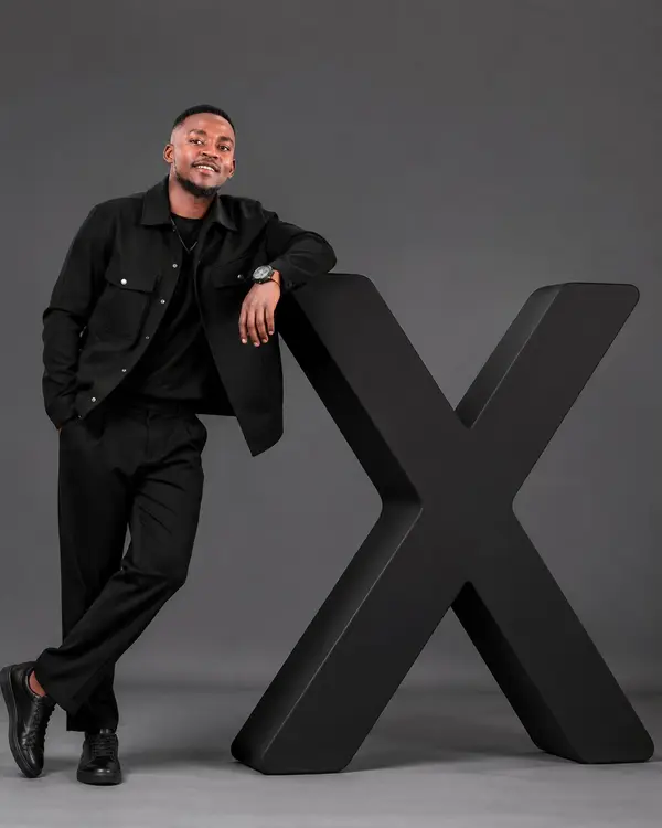 A hyper-realistic editorial photograph of a stylish man confidently interacting… — AI Model prompt by @NjiwaFLow