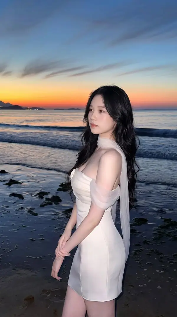 Ultra-realistic portrait of a beautiful young East Asian woman standing on a… — Nano Banana 2 prompt by @kingofdairyque