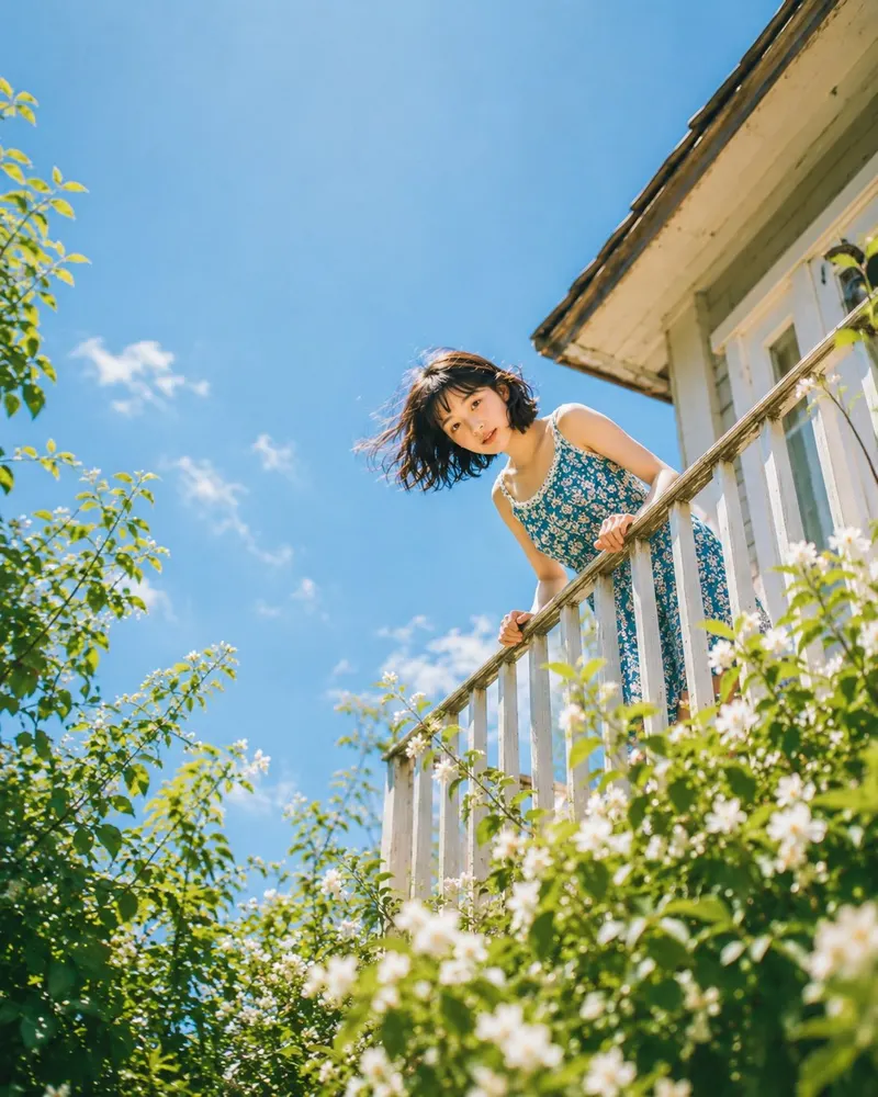 Close-up shot from low angle, young woman's face peeking over white balcony… — GPT Image 2 prompt by @meng_dagg695