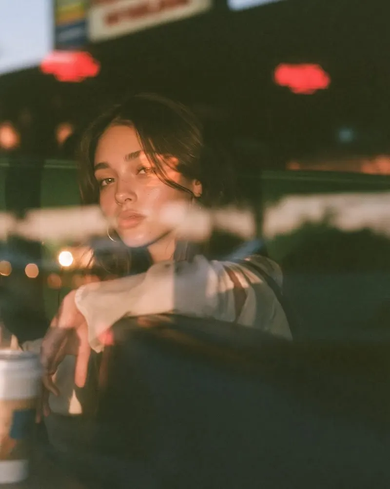 Ultra-cinematic lifestyle portrait photographed through a café window at blue… — GPT Image 2 prompt by @Taaruk_