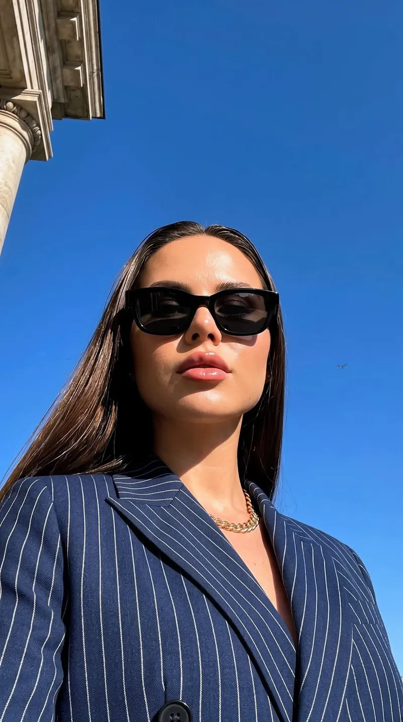A luxury fashion editorial portrait of a stylish woman wearing a tailored navy… — GPT Image 2 prompt by @Sairah_0