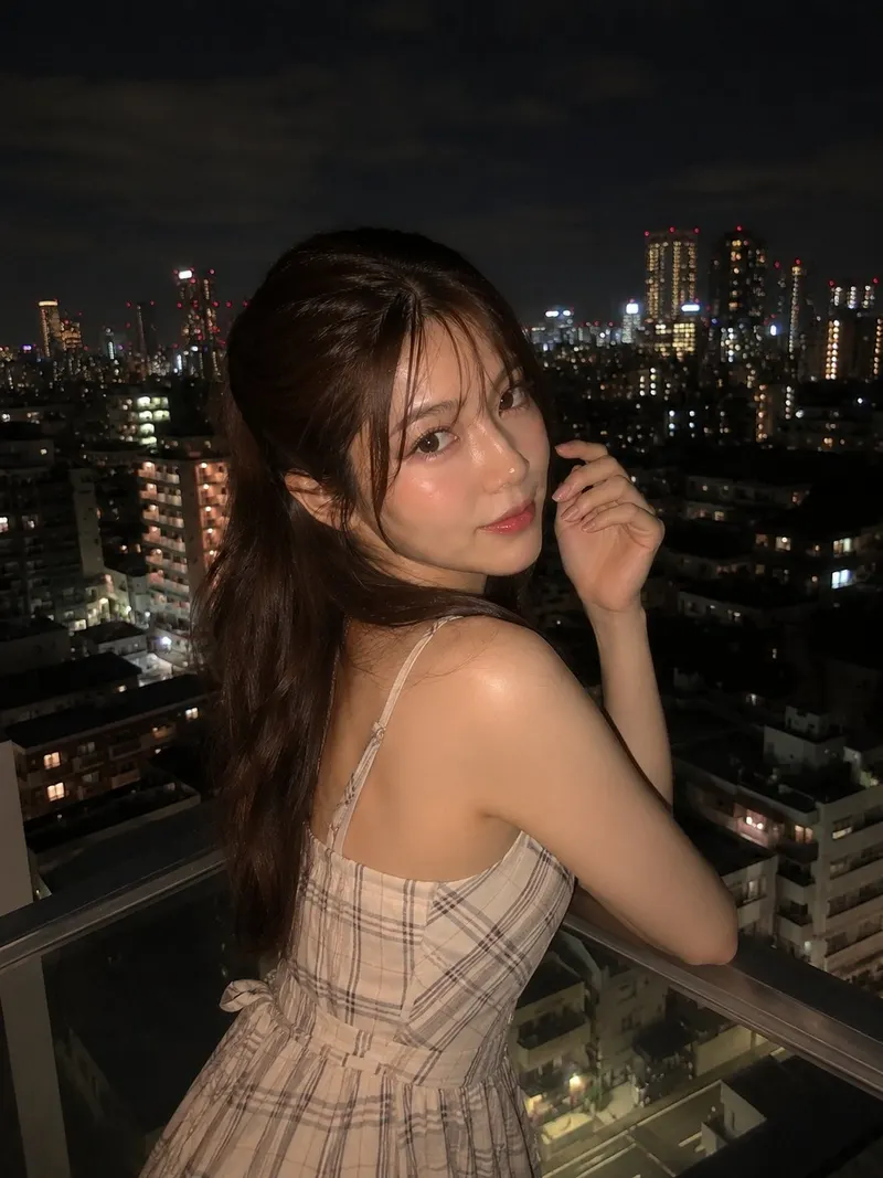 Ultra-realistic night portrait of a beautiful young woman standing on a balcony… — GPT Image 2 prompt by @saniaspeaks_