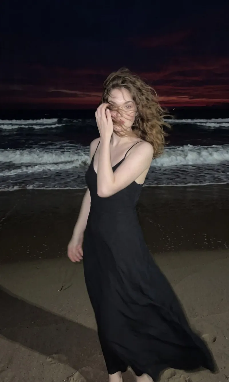 Photorealistic nighttime lifestyle fashion photo of a woman on a beach by the… — Nano Banana 2 prompt by @SimplyAnnisa