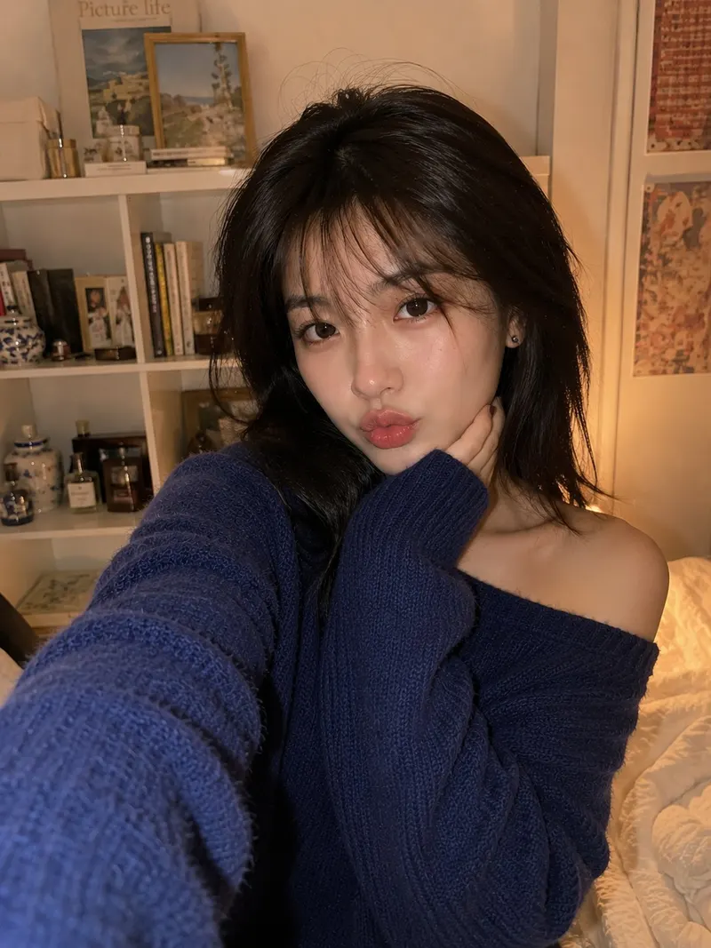 Smartphone selfie of a beautiful young East Asian woman indoors in a cozy… — GPT Image 2 prompt by @saniaspeaks_